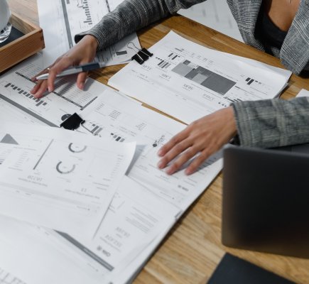 papers with graphs and charts on a table